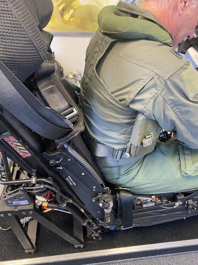 Close view of a pilot strapped into a Martin-Baker ejection seat during a measurement session